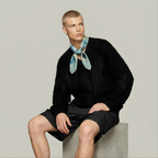 Mlle Ceinté Paris silk scarf, jumping horse with floral pattern coat, navy blue saddle and orange trim, sage green grid background.