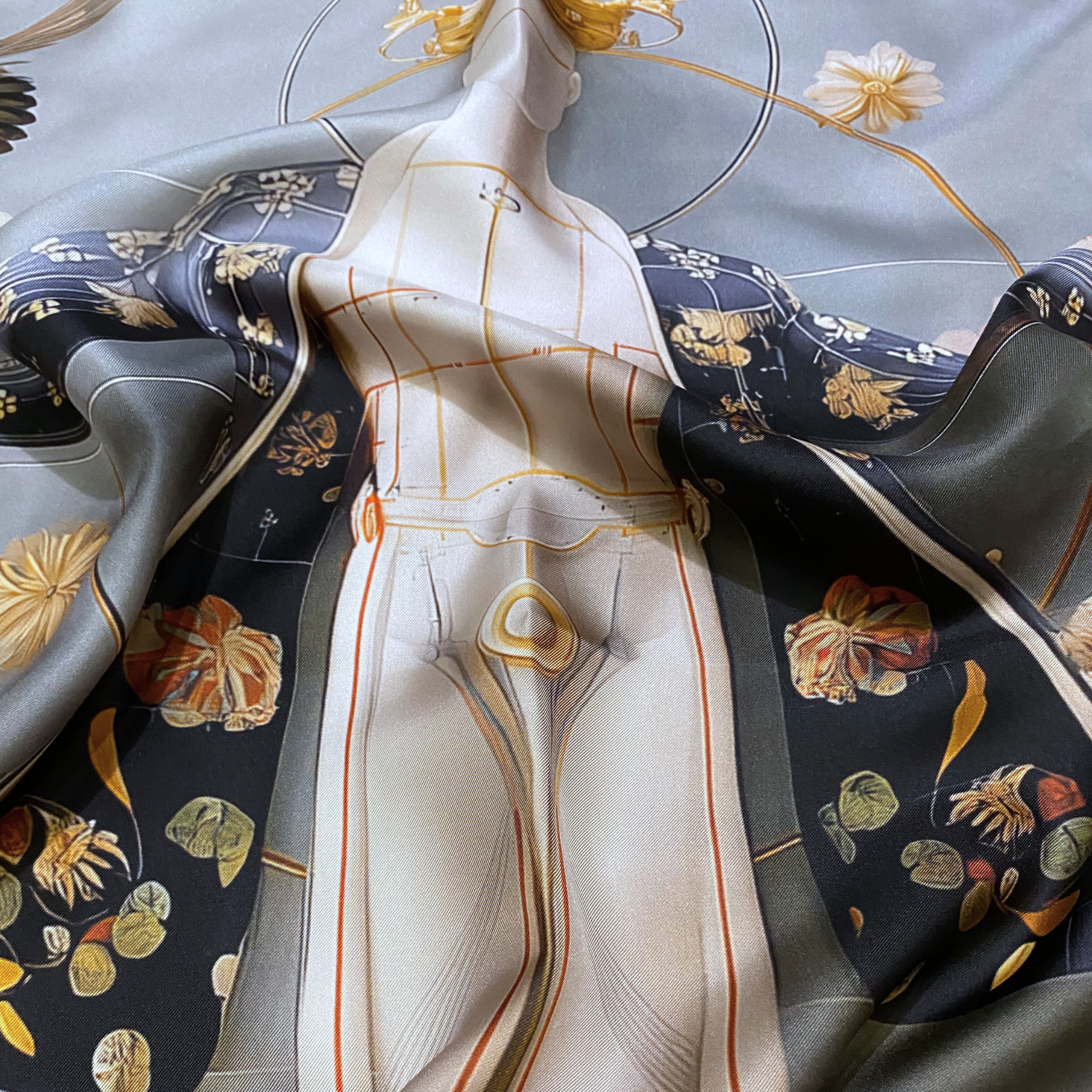 Mlle Ceinté Paris silk scarf, central anatomical mannequin figure with crown, surrounded by peonies and birds, grey and gold surrealist design