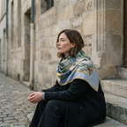 Mlle Ceinté Paris silk scarf, blue scaled dragon intertwining with classical marble statues, sky blue background with orange accents, hand-rolled hem.