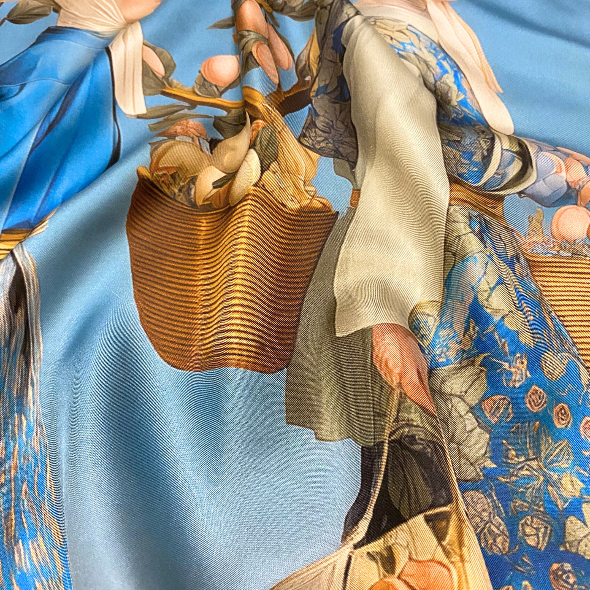 Mlle Ceinté Paris silk scarf, three figures carrying baskets of peaches, blue floral clothing, blue sky background harvest procession.