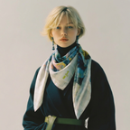 Mlle Ceinté silk scarf, seated blue mosaic sculpture figure wearing yellow boots, modern art design, architectural grid background.