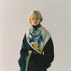 Mlle Ceinté silk scarf, seated blue mosaic sculpture figure wearing yellow boots, modern art design, architectural grid background.