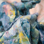 Mlle Ceinté silk scarf, seated blue mosaic sculpture figure wearing yellow boots, modern art design, architectural grid background.